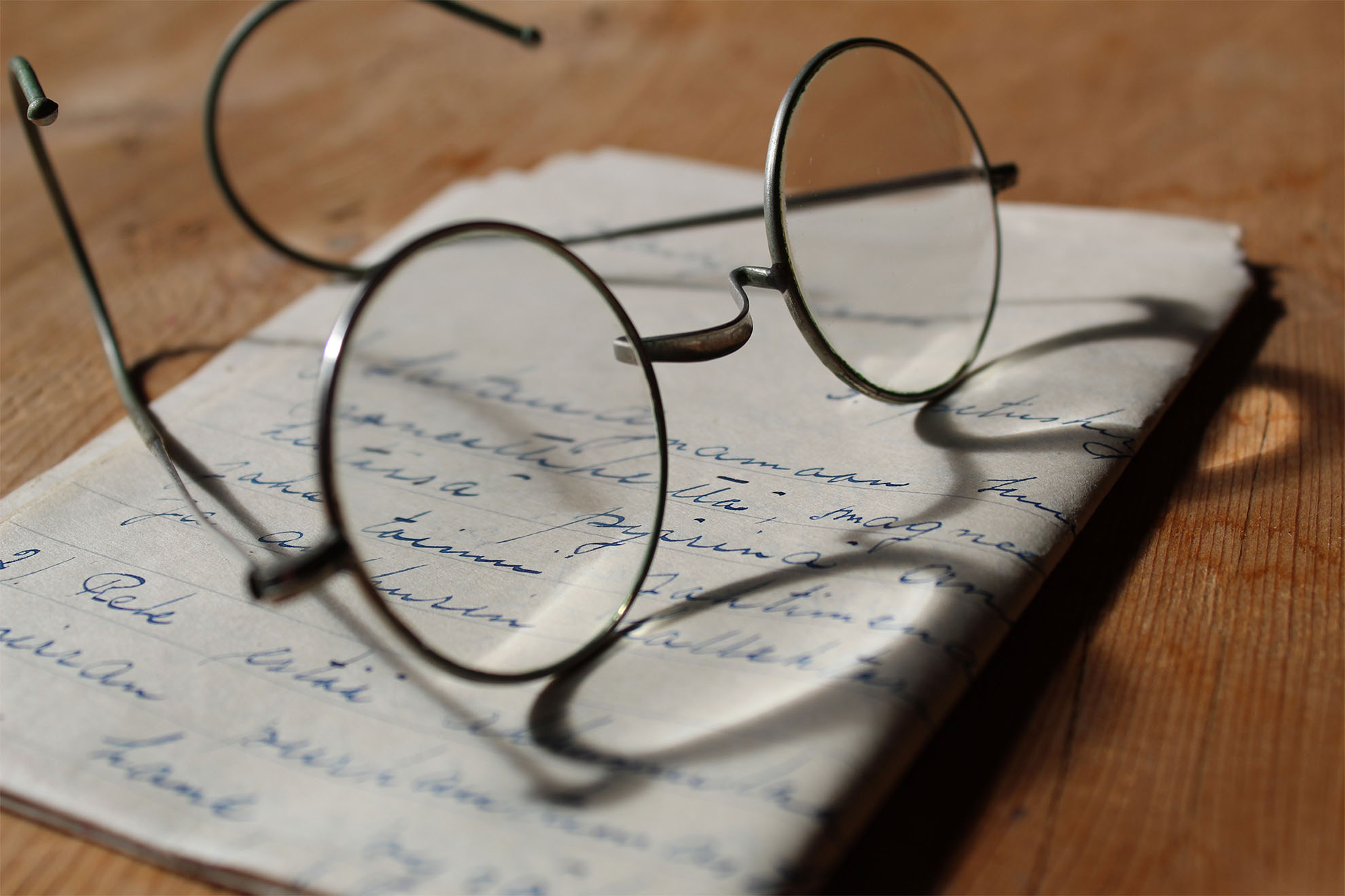 a letter sat on the side with a pair of glasses on top