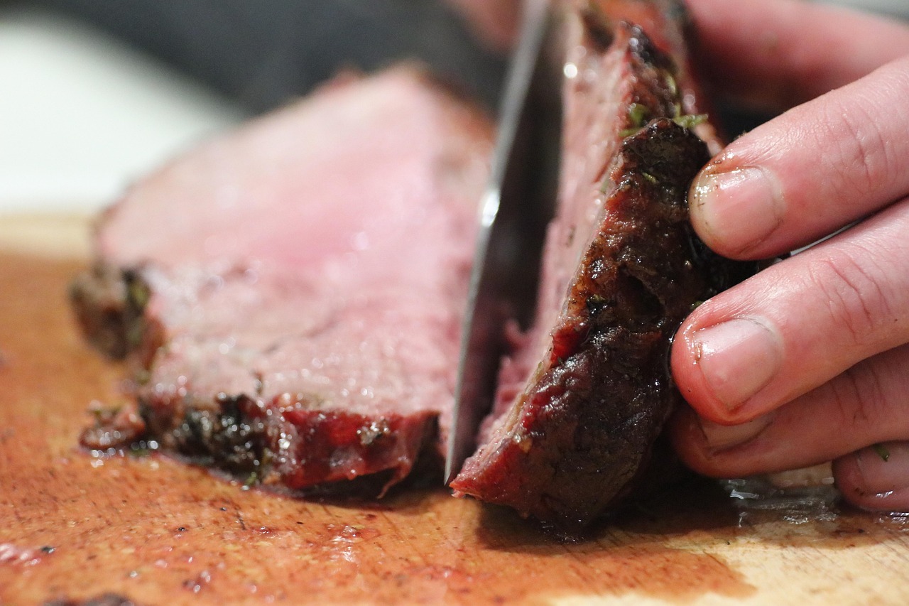 Chef slicing meat with a knife